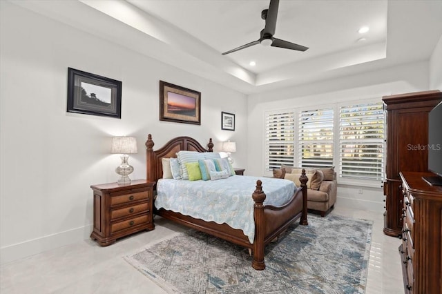 bedroom featuring a tray ceiling and ceiling fan