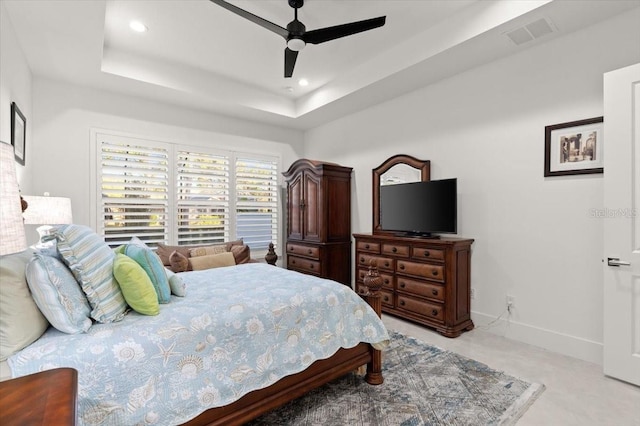 bedroom featuring a tray ceiling and ceiling fan