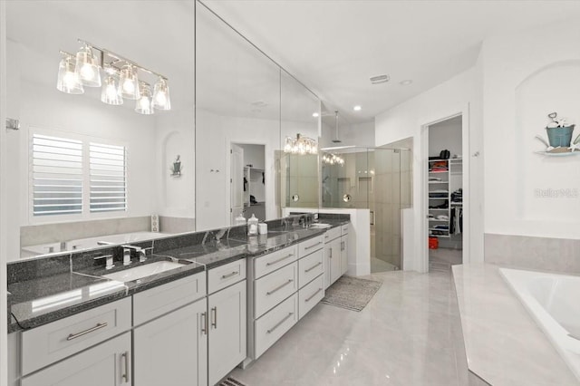 bathroom featuring shower with separate bathtub and vanity