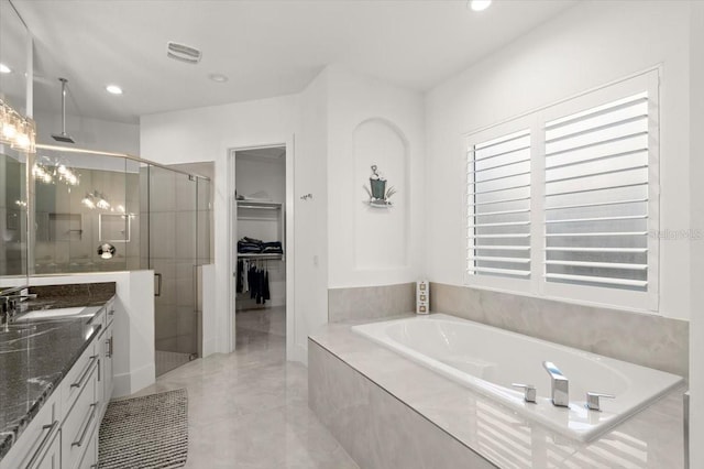 bathroom featuring tile patterned flooring, vanity, and separate shower and tub