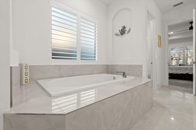 bathroom featuring tiled tub