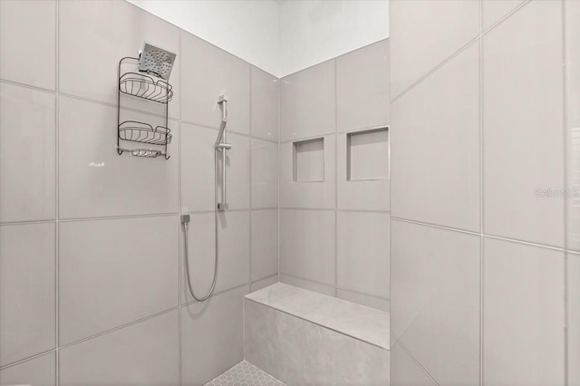 bathroom with a tile shower