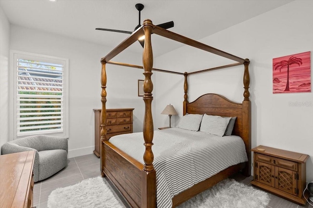 tiled bedroom featuring ceiling fan