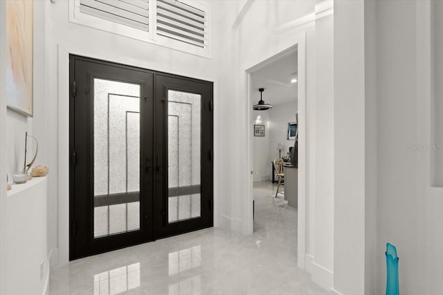 entryway with french doors and a high ceiling