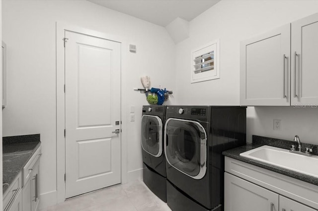 laundry room featuring washer and dryer, light tile patterned floors, cabinets, and sink