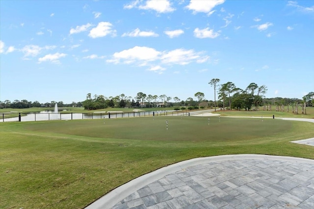 surrounding community featuring a water view and a yard