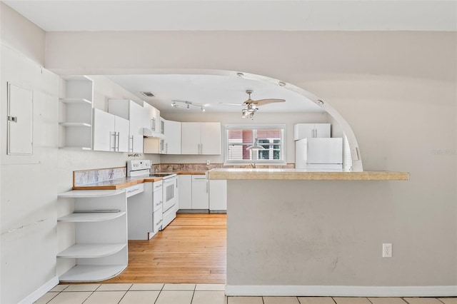 kitchen featuring ceiling fan, range hood, white appliances, white cabinets, and light wood-type flooring