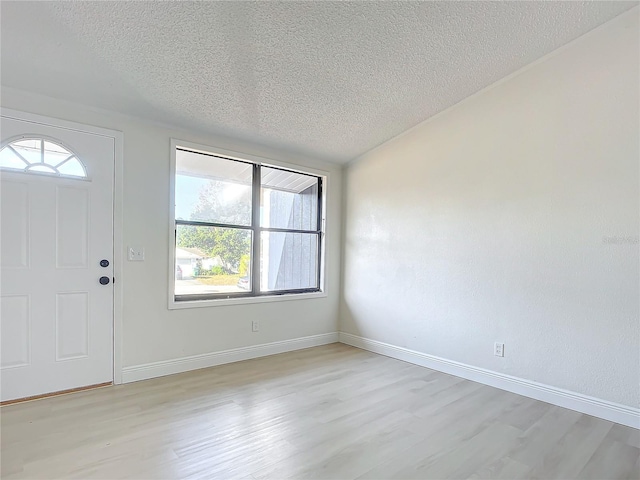 entryway featuring a textured ceiling and light wood-type flooring