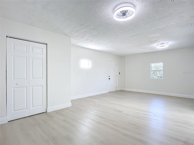 interior space with light hardwood / wood-style floors and a textured ceiling