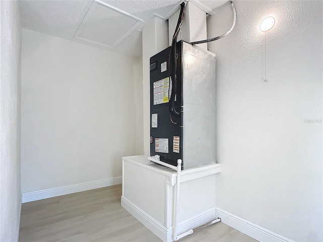 interior space featuring hardwood / wood-style flooring and heating unit