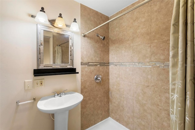 bathroom with a shower with shower curtain and sink