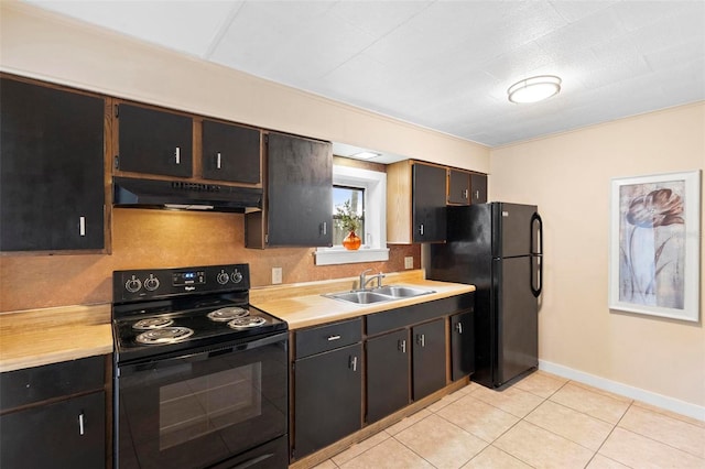 kitchen with black appliances, dark brown cabinetry, light tile patterned floors, and sink