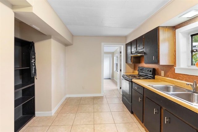 kitchen featuring dark brown cabinetry, sink, light tile patterned floors, and black electric range