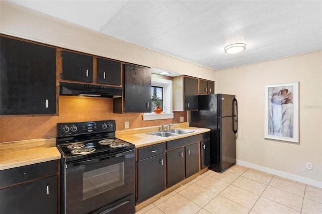 kitchen featuring dark brown cabinetry, sink, light tile patterned flooring, and black appliances