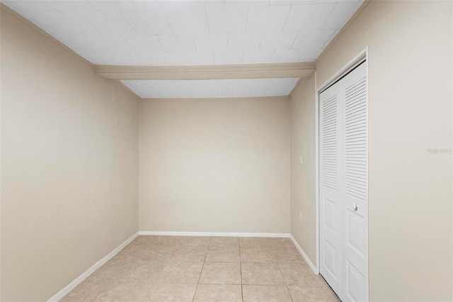 unfurnished bedroom with a closet and light tile patterned flooring