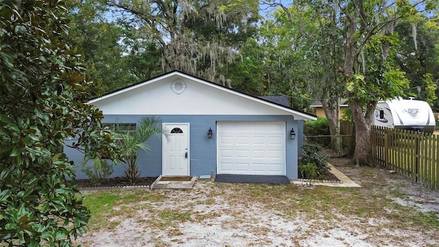 view of front of property featuring a garage and an outdoor structure