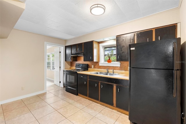 kitchen featuring sink, light tile patterned floors, and black appliances