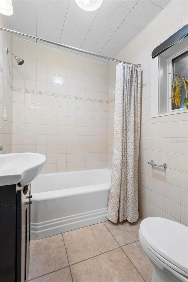 bathroom featuring shower / tub combo, toilet, tile walls, and tile patterned floors