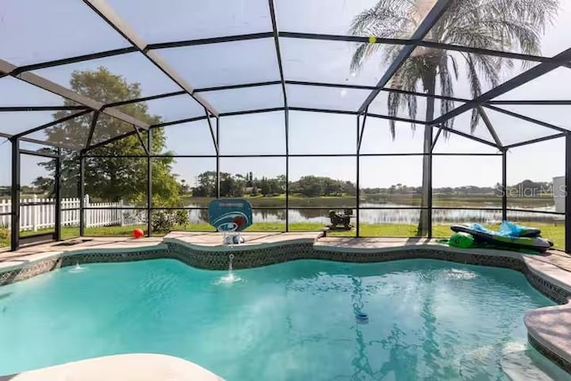 view of pool featuring a lanai, a water view, a patio, and pool water feature