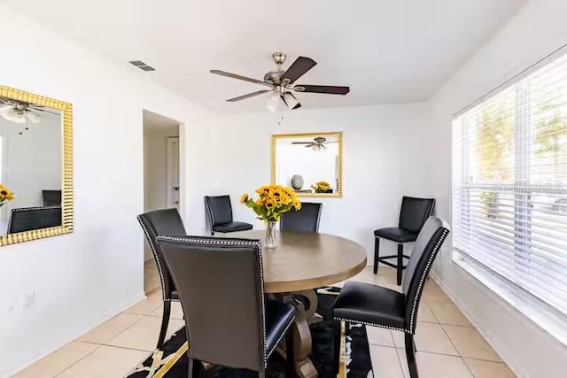 dining space featuring ceiling fan and light tile patterned flooring