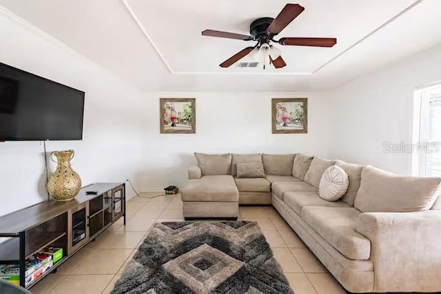 tiled living room with ceiling fan