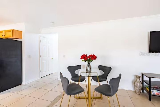 tiled dining room with ornamental molding