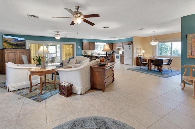 living room with light tile patterned floors and ceiling fan