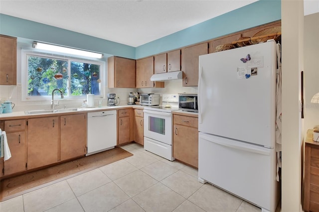 kitchen with light tile patterned floors, white appliances, backsplash, and sink