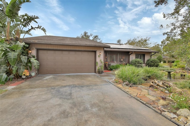 view of front of property with solar panels and a garage