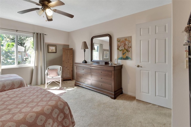 bedroom with ceiling fan and light carpet