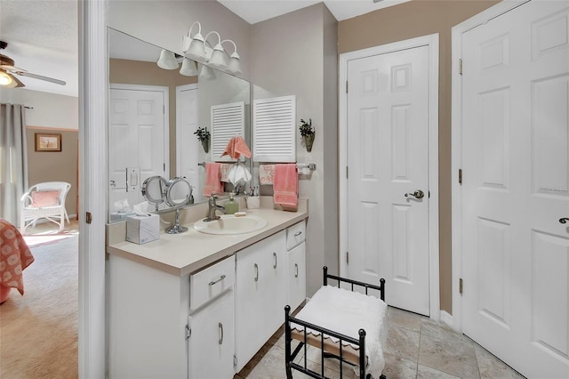 bathroom featuring ceiling fan and vanity