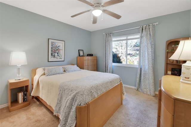 bedroom with ceiling fan and light colored carpet