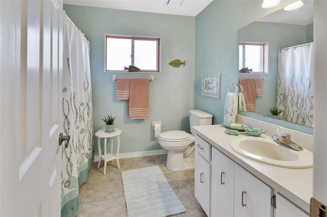 bathroom with toilet, vanity, and tile patterned floors