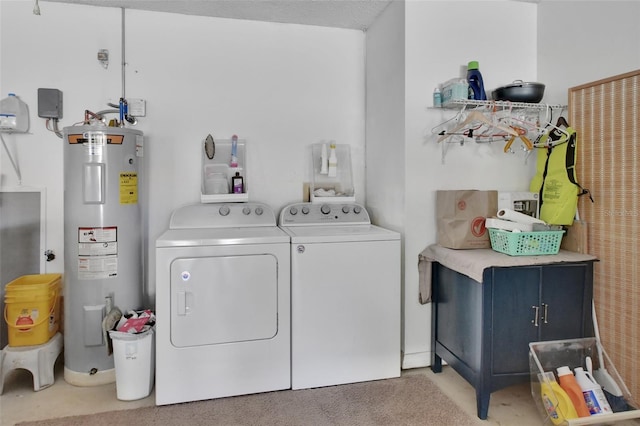 washroom with water heater, carpet floors, and washer and dryer