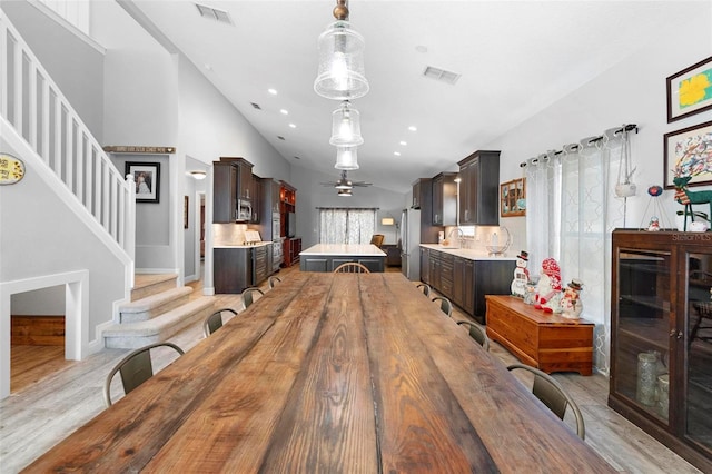 dining area featuring light hardwood / wood-style flooring, ceiling fan, and sink