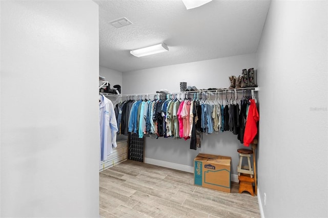 walk in closet featuring hardwood / wood-style floors