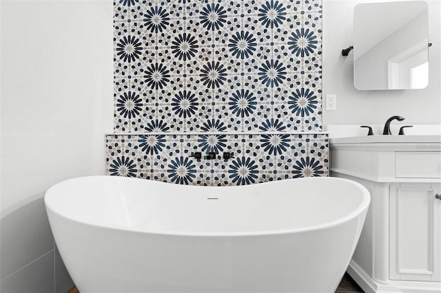 bathroom featuring a bathtub, tile walls, and vanity