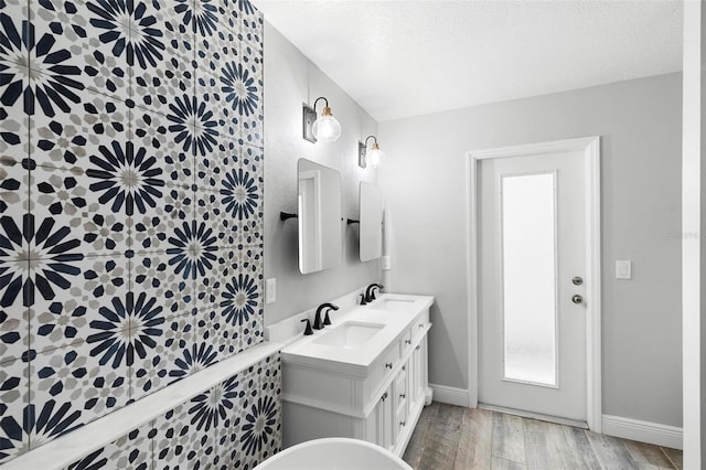 bathroom featuring vanity, wood-type flooring, and a textured ceiling