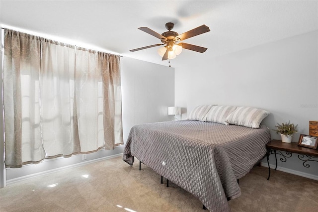 bedroom with ceiling fan and light colored carpet