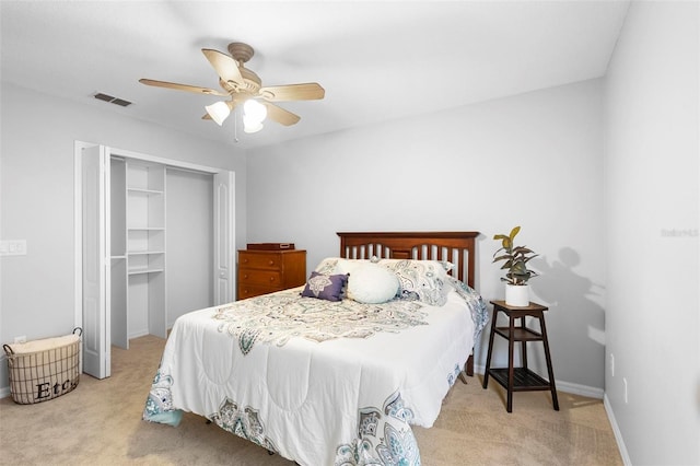 carpeted bedroom featuring ceiling fan and a closet