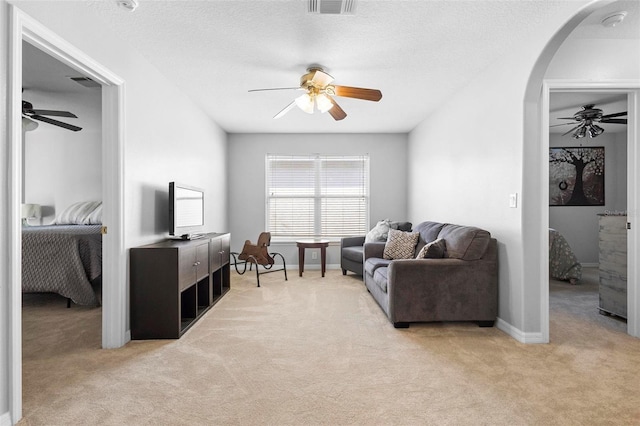 carpeted living room with a textured ceiling