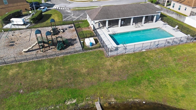 view of swimming pool featuring a yard, a playground, and a patio area