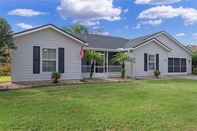 ranch-style house with a front yard and a sunroom