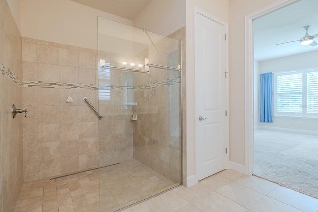 bathroom with tile patterned floors, ceiling fan, and a tile shower