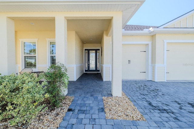 doorway to property with a garage