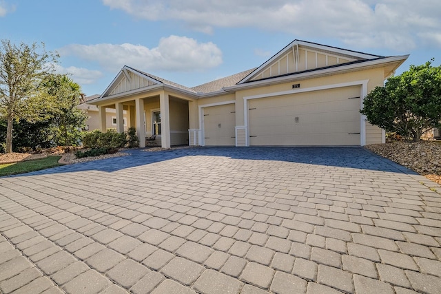 view of front of home with a porch and a garage