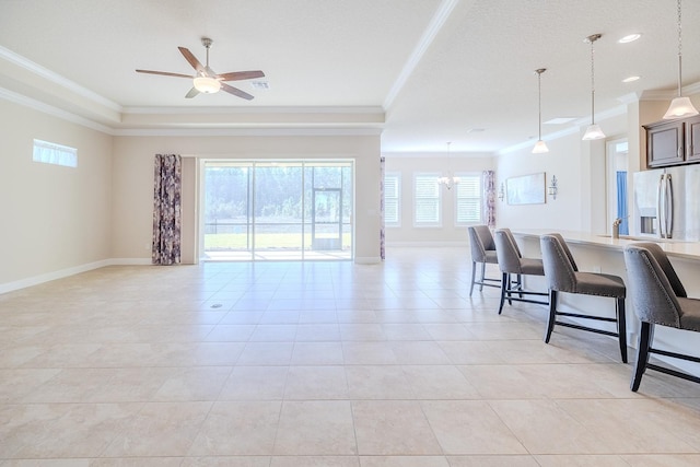 living room with ceiling fan with notable chandelier, ornamental molding, and light tile patterned flooring