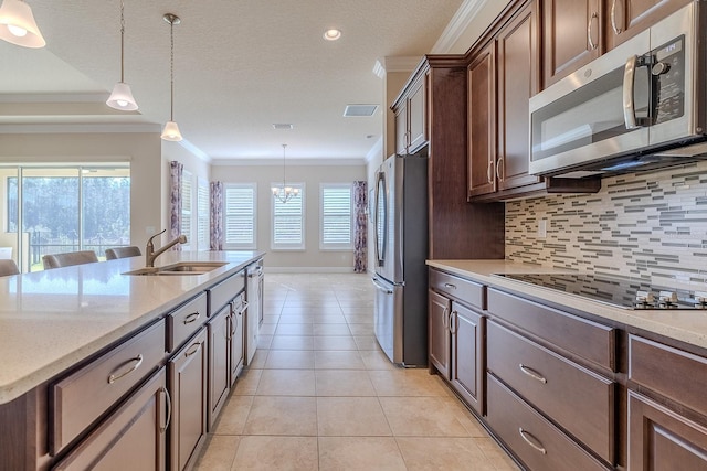 kitchen featuring crown molding, sink, pendant lighting, and appliances with stainless steel finishes