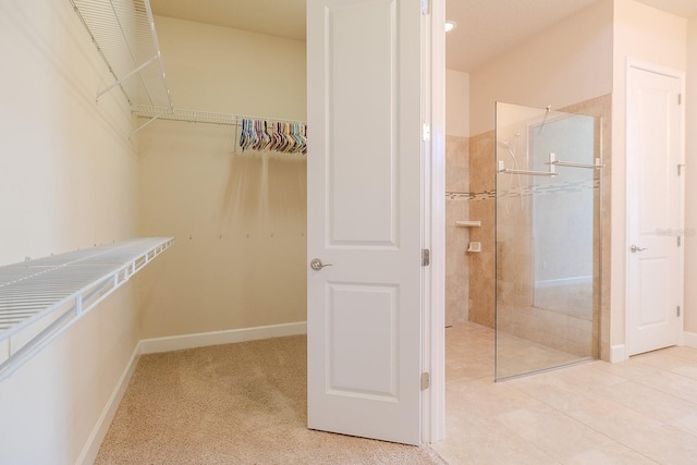 spacious closet featuring light tile patterned floors