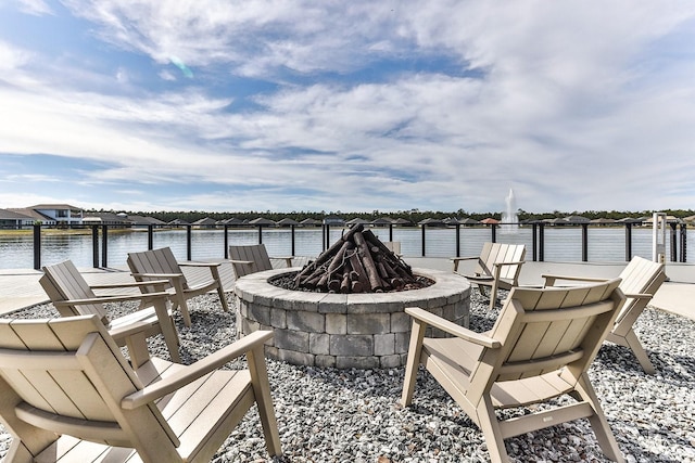 view of patio with a water view and an outdoor fire pit